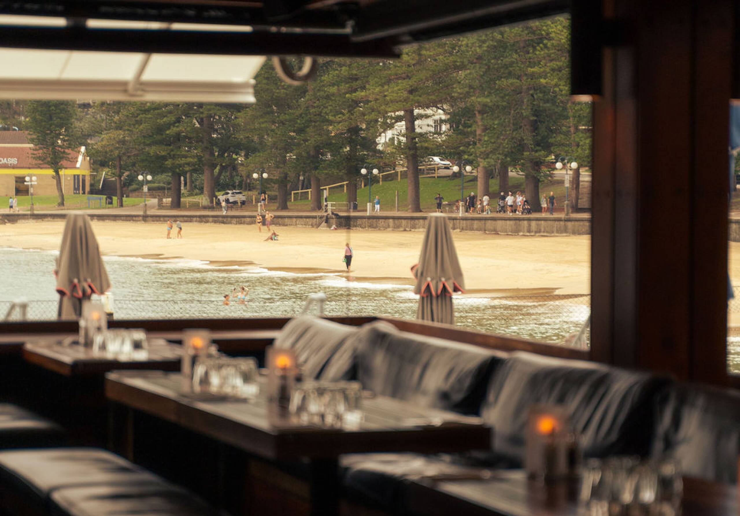 Banquette seating inside Hugos Manly looking out to Manly Beach